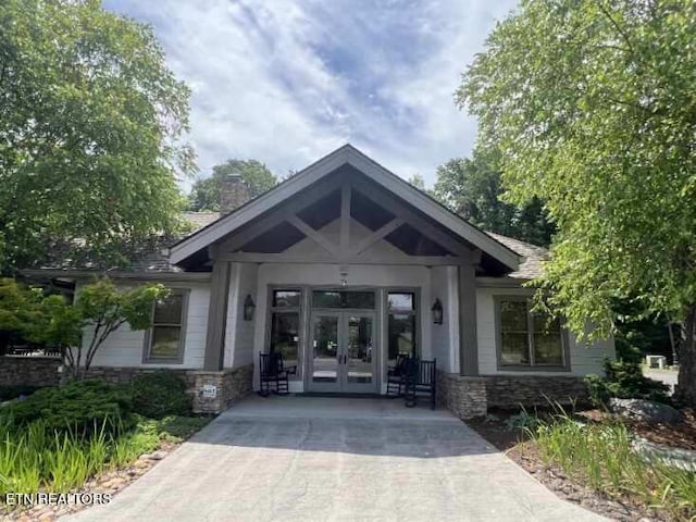 326 Shooting Star Loop Unit 201, Townsend, TN 37882 - property entrance with french doors, stone siding, and a chimney