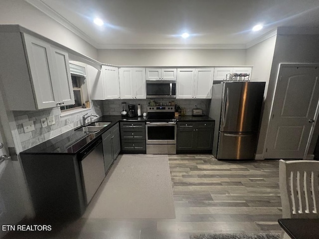 326 Shooting Star Loop Unit 201, Townsend, TN 37882 - kitchen featuring stainless steel appliances, dark countertops, crown molding, white cabinets, and backsplash