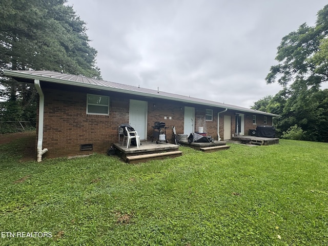 1637 Jefferson St, Morristown, TN 37814 - rear view of house with brick siding, a lawn, a metal roof, and crawl space