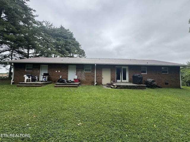 1637 Jefferson St, Morristown, TN 37814 - rear view of property featuring brick siding, a yard, a patio area, and a metal roof