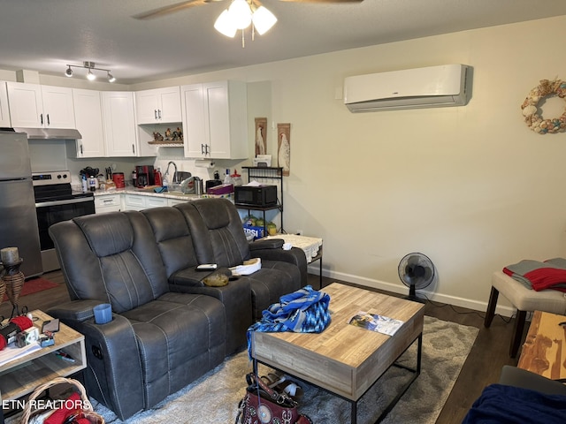 1637 Jefferson St, Morristown, TN 37814 - living area featuring a wall mounted air conditioner, a ceiling fan, and wood finished floors