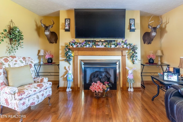 361 River Dr, Dunlap, TN 37327 - living area with a glass covered fireplace, hardwood / wood-style floors, and a textured ceiling