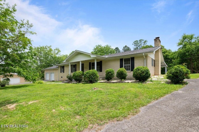 220 Lillywood Dr, Lafollette, TN 37766 - single story home with a chimney, an attached garage, brick siding, and a front lawn