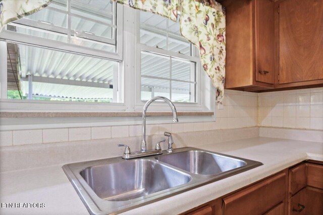 220 Lillywood Dr, Lafollette, TN 37766 - kitchen with brown cabinets, light countertops, and decorative backsplash