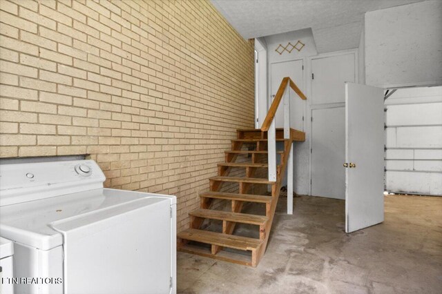 220 Lillywood Dr, Lafollette, TN 37766 - laundry area with brick wall and washer and clothes dryer