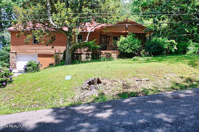 705 S 11th St, Lafollette, TN 37766 - view of front facade with an attached garage, a front yard, and stone siding