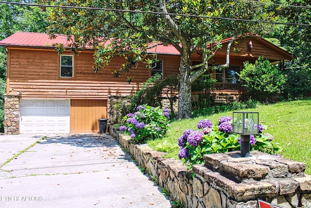 705 S 11th St, Lafollette, TN 37766 - chalet / cabin with a garage, concrete driveway, a metal roof, and a front yard