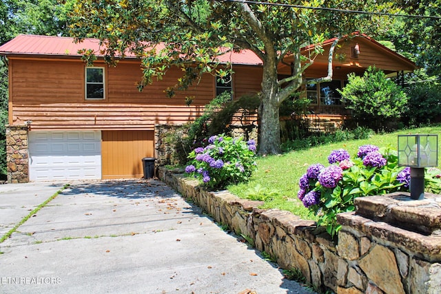 705 S 11th St, Lafollette, TN 37766 - view of front facade with a garage, concrete driveway, and a metal roof