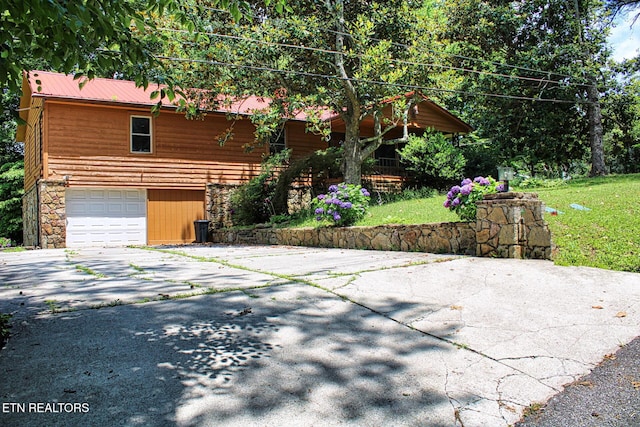 705 S 11th St, Lafollette, TN 37766 - view of front facade with asphalt driveway, an attached garage, and stone siding