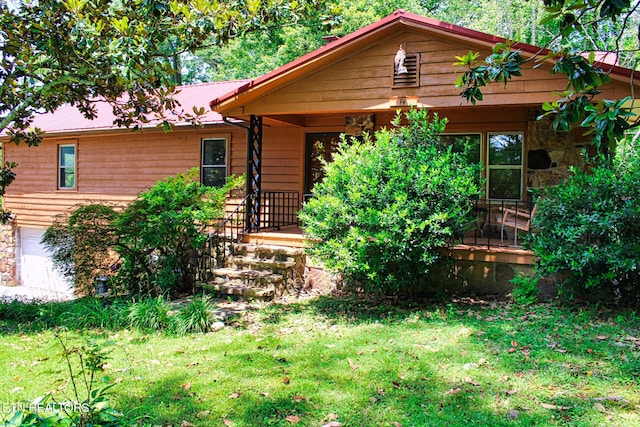 705 S 11th St, Lafollette, TN 37766 - view of front of house featuring a front yard, a metal roof, and stone siding