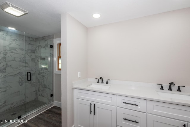 957 W Hunt Rd, Alcoa, TN 37701 - bathroom featuring a marble finish shower, wood finished floors, double vanity, and recessed lighting