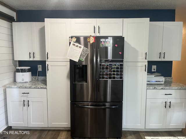 203 Baker Cir, Maynardville, TN 37807 - kitchen with fridge with ice dispenser, dark wood finished floors, white cabinets, and light stone countertops