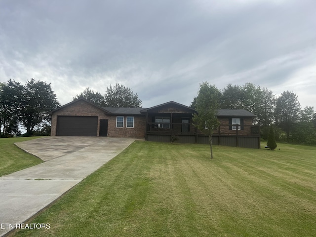 203 Baker Cir, Maynardville, TN 37807 - ranch-style home featuring a front yard, concrete driveway, a garage, and brick siding