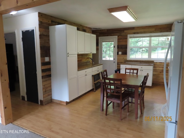 110 Dale Rd, Oakdale, TN 37829 - dining space with wood walls and light wood-style floors