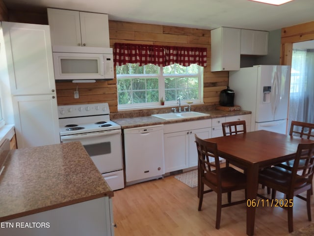 110 Dale Rd, Oakdale, TN 37829 - kitchen with white appliances, wooden walls, white cabinetry, and light wood-type flooring