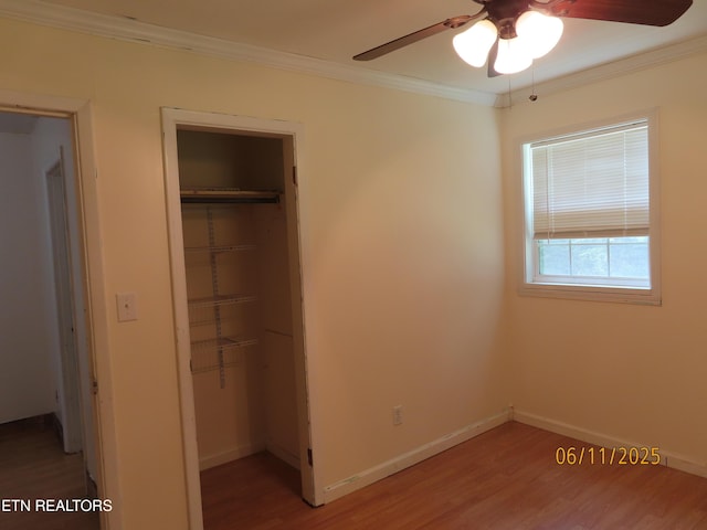 110 Dale Rd, Oakdale, TN 37829 - unfurnished bedroom featuring a closet, ornamental molding, wood finished floors, a ceiling fan, and a spacious closet