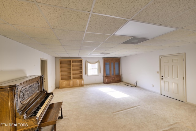 609 Lane Hollow Rd, Sevierville, TN 37876 - unfurnished living room featuring a wood stove, built in shelves, carpet floors, and a paneled ceiling