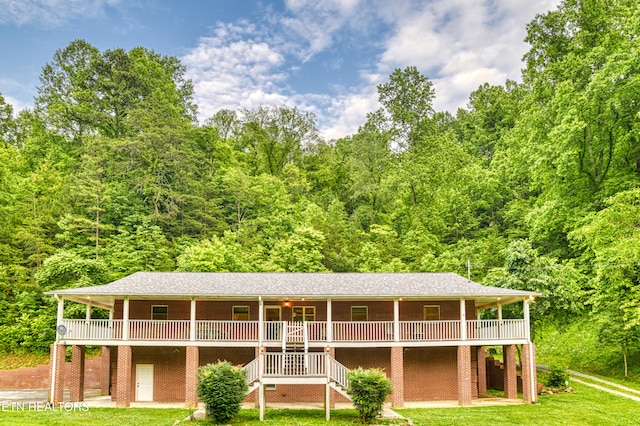 609 Lane Hollow Rd, Sevierville, TN 37876 - rear view of house featuring a yard, a wooded view, and stairway