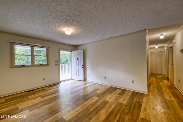 609 Lane Hollow Rd, Sevierville, TN 37876 - empty room featuring a textured ceiling, wood finished floors, and crown molding