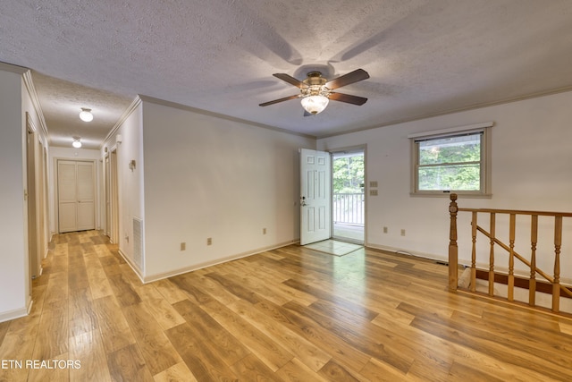 609 Lane Hollow Rd, Sevierville, TN 37876 - empty room with a textured ceiling, a ceiling fan, light wood-style flooring, and crown molding