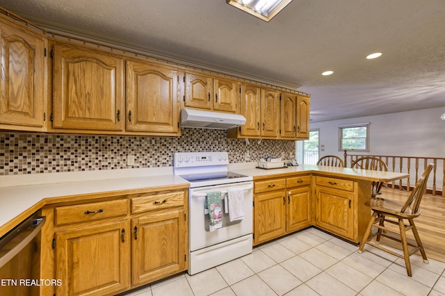 609 Lane Hollow Rd, Sevierville, TN 37876 - kitchen with white range with electric stovetop, under cabinet range hood, a peninsula, dishwasher, and light countertops