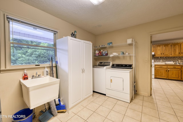 609 Lane Hollow Rd, Sevierville, TN 37876 - laundry room with light tile patterned flooring, washer and clothes dryer, and a textured ceiling