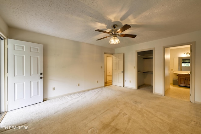 609 Lane Hollow Rd, Sevierville, TN 37876 - unfurnished bedroom with light carpet, a textured ceiling, ensuite bath, a closet, and a ceiling fan