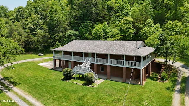 609 Lane Hollow Rd, Sevierville, TN 37876 - rear view of property featuring driveway, a forest view, a wooden deck, stairs, and a lawn