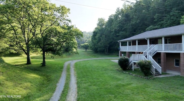 609 Lane Hollow Rd, Sevierville, TN 37876 - view of grassy yard featuring stairs, driveway, and covered porch