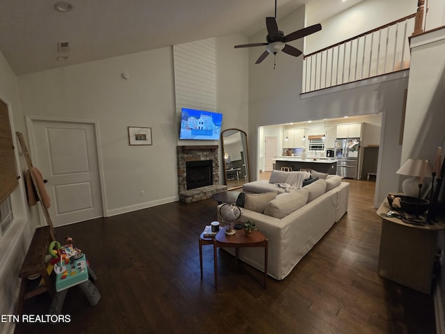 6312 Knightsboro Rd, Knoxville, TN 37912 - living room with high vaulted ceiling, ceiling fan, a stone fireplace, and dark wood finished floors
