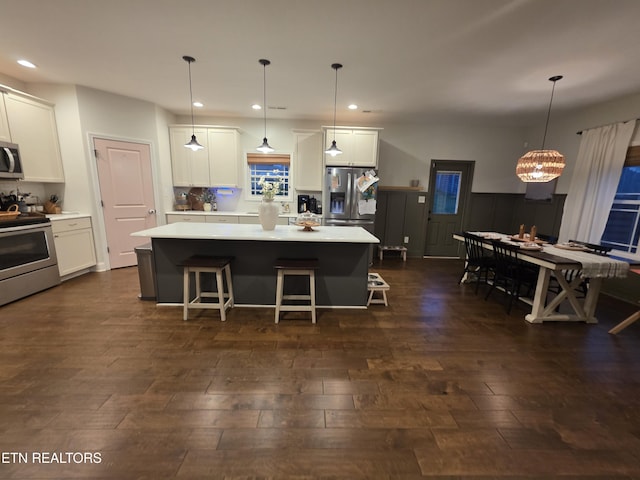 6312 Knightsboro Rd, Knoxville, TN 37912 - kitchen featuring stainless steel appliances, a kitchen island, white cabinets, recessed lighting, and wainscoting