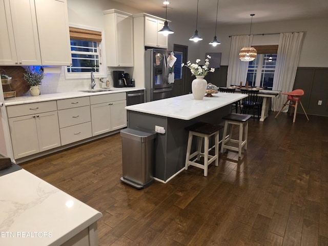 6312 Knightsboro Rd, Knoxville, TN 37912 - kitchen with stainless steel fridge with ice dispenser, dark wood-style flooring, a kitchen bar, a kitchen island, and white cabinetry