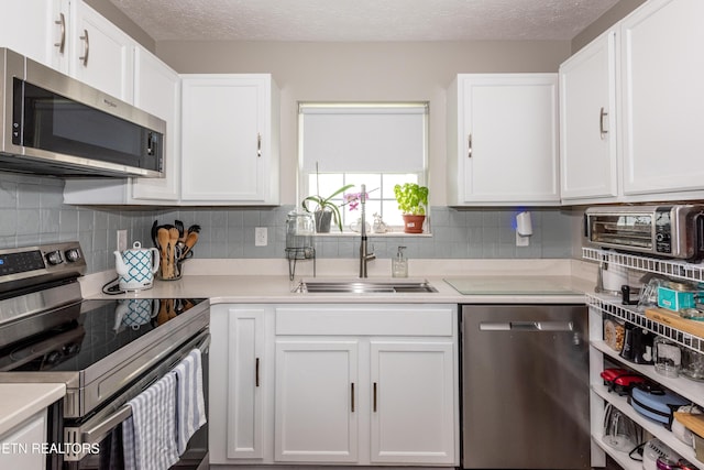 2544 Bay Meadows Way, Sevierville, TN 37876 - kitchen featuring stainless steel appliances, white cabinets, light countertops, and a textured ceiling
