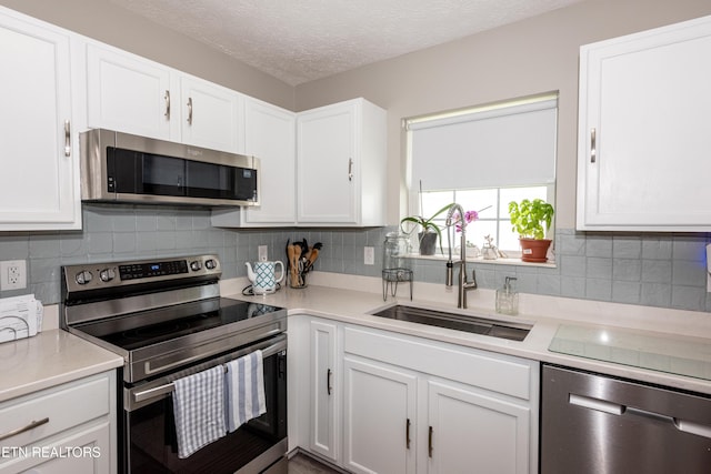 2544 Bay Meadows Way, Sevierville, TN 37876 - kitchen featuring stainless steel appliances, white cabinetry, light countertops, and a textured ceiling