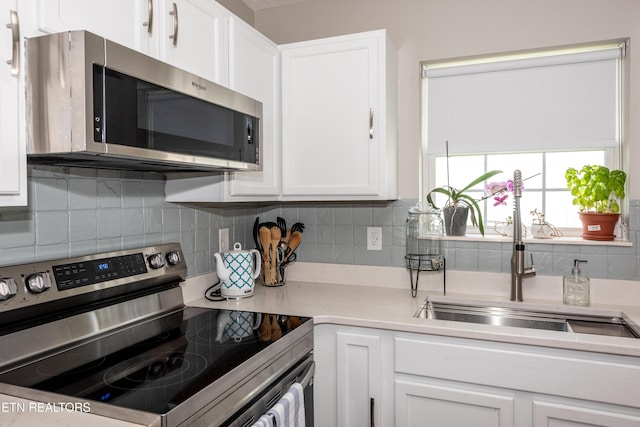 2544 Bay Meadows Way, Sevierville, TN 37876 - kitchen with appliances with stainless steel finishes, white cabinetry, and tasteful backsplash