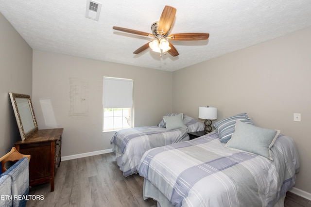 2544 Bay Meadows Way, Sevierville, TN 37876 - bedroom with wood finished floors, a ceiling fan, and a textured ceiling