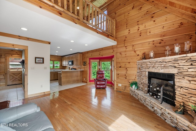 152 Eagle Crst, Tazewell, TN 37879 - living room with healthy amount of natural light, light wood-style flooring, a fireplace, recessed lighting, and wooden walls