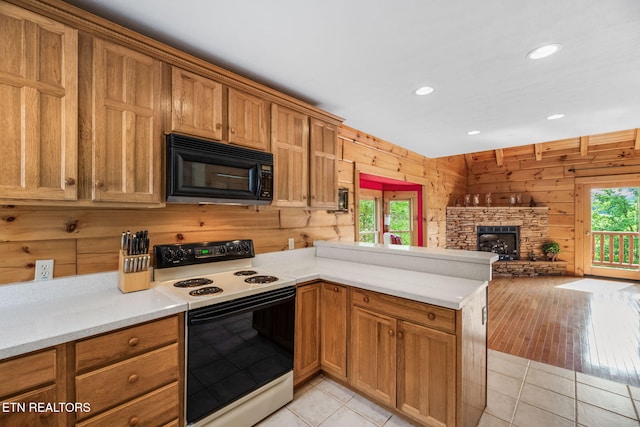 152 Eagle Crst, Tazewell, TN 37879 - kitchen with range with electric stovetop, black microwave, wooden walls, a peninsula, and light countertops