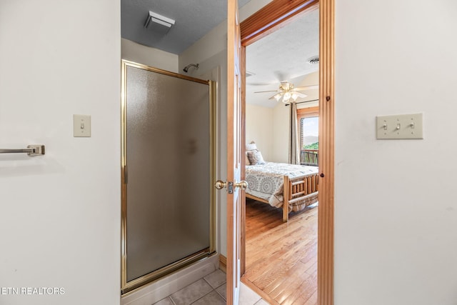 152 Eagle Crst, Tazewell, TN 37879 - bathroom featuring a stall shower, connected bathroom, a ceiling fan, and tile patterned floors