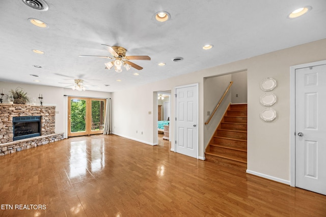 152 Eagle Crst, Tazewell, TN 37879 - unfurnished living room featuring a ceiling fan, recessed lighting, a stone fireplace, wood finished floors, and stairway