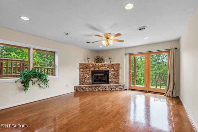 152 Eagle Crst, Tazewell, TN 37879 - unfurnished living room featuring wood finished floors, a ceiling fan, recessed lighting, and a stone fireplace