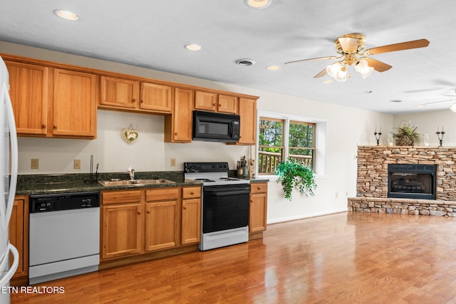 152 Eagle Crst, Tazewell, TN 37879 - kitchen with dishwasher, range with electric cooktop, black microwave, a ceiling fan, and light wood finished floors