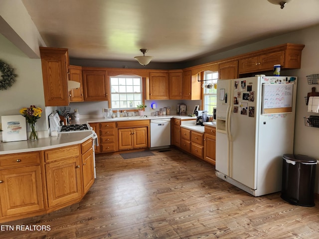 1865 Campground Rd, Clarkrange, TN 38553 - kitchen with white appliances, wood finished floors, exhaust hood, and light countertops