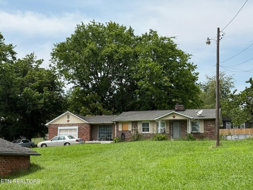 6921 Old Rutledge Pike, Knoxville, TN 37924 - view of front of home with brick siding, a garage, and a chimney