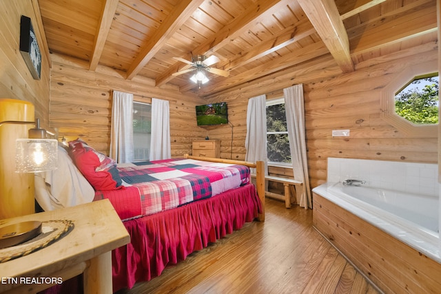 3319 Covered Bridge Way, Sevierville, TN 37862 - bedroom with multiple windows, wood finished floors, a wood ceiling with exposed beams, and rustic walls
