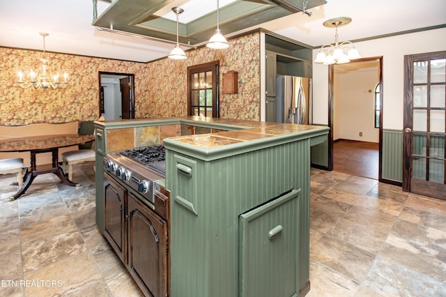146 Lake Hills Dr, Oak Ridge, TN 37830 - kitchen with green cabinets, a chandelier, wallpapered walls, stainless steel gas cooktop, and light stone finish flooring
