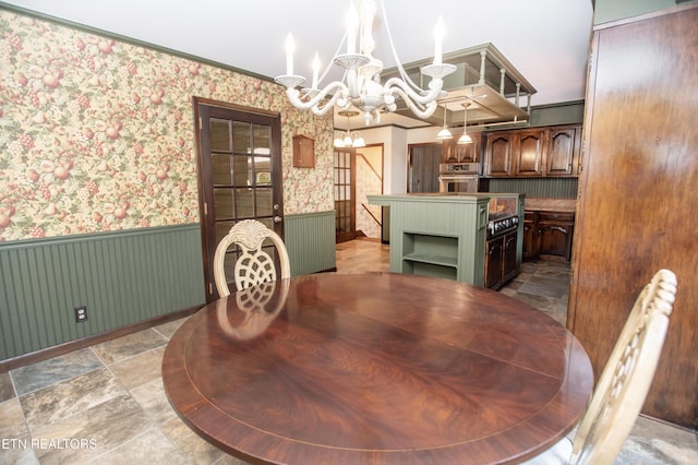 146 Lake Hills Dr, Oak Ridge, TN 37830 - dining space featuring a chandelier, a wainscoted wall, stone finish flooring, and wallpapered walls