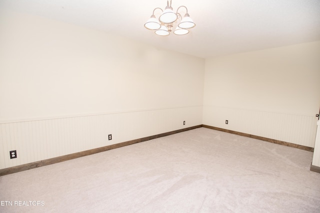 146 Lake Hills Dr, Oak Ridge, TN 37830 - carpeted empty room featuring a chandelier and a wainscoted wall