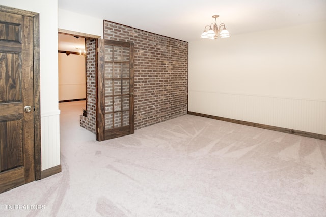 146 Lake Hills Dr, Oak Ridge, TN 37830 - unfurnished room featuring brick wall, carpet floors, a wainscoted wall, and a chandelier