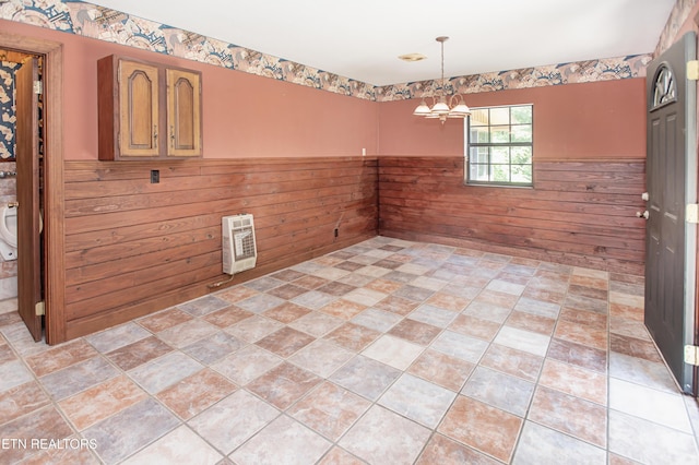 146 Lake Hills Dr, Oak Ridge, TN 37830 - spare room featuring a chandelier, wooden walls, a wainscoted wall, and heating unit